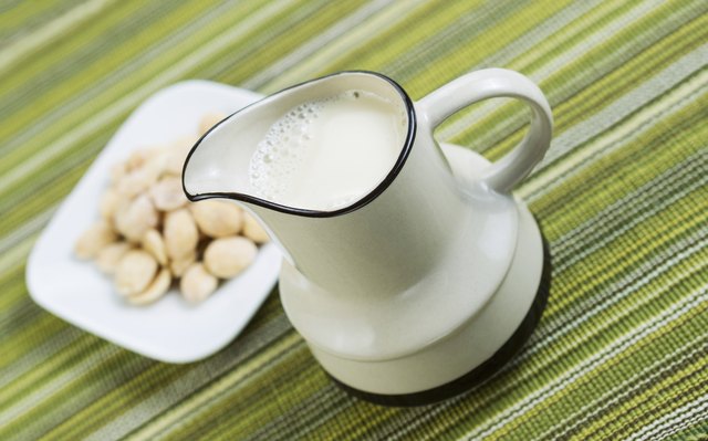 Almond milk in pourer with Almonds