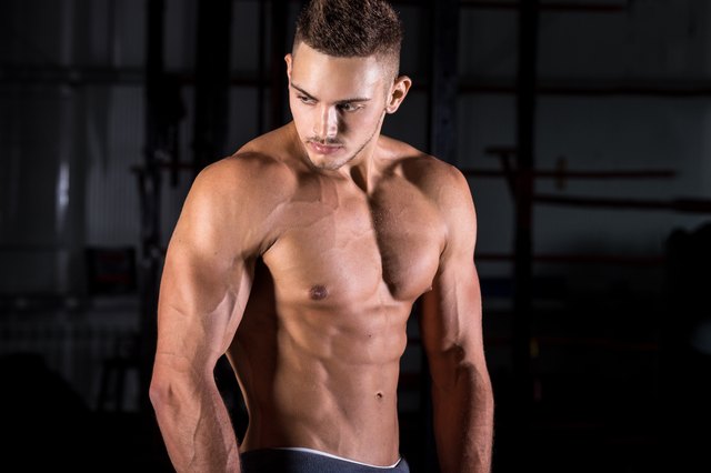 Handsome muscular young man in gym
