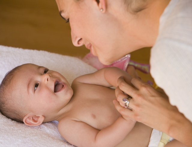 Hispanic mother smiling at baby