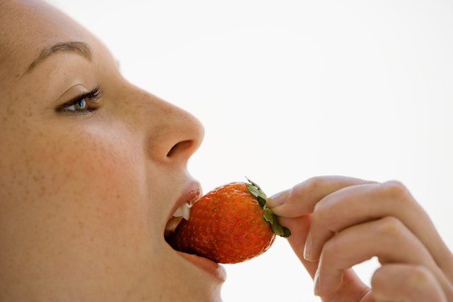 Woman eating strawberry