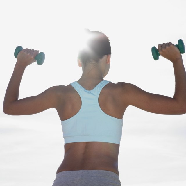 Mixed Race woman lifting weights