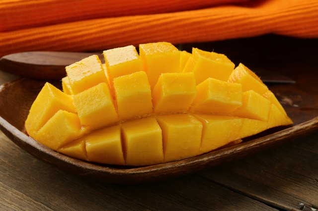 fresh fruit mango on wooden plate