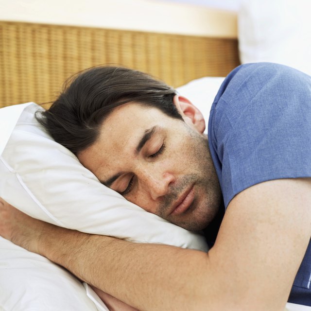 close-up of a young man sleeping on the bed