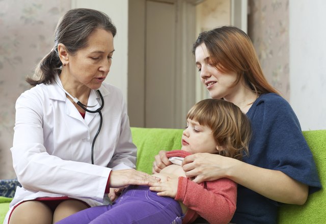 mature children's doctor examining baby