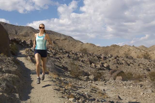 Young woman jogging in mountains