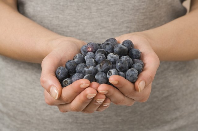 Woman holding fresh blueberries