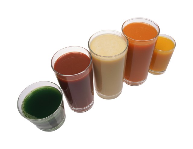 Glasses of fruit and vegetable juices, arranged in row