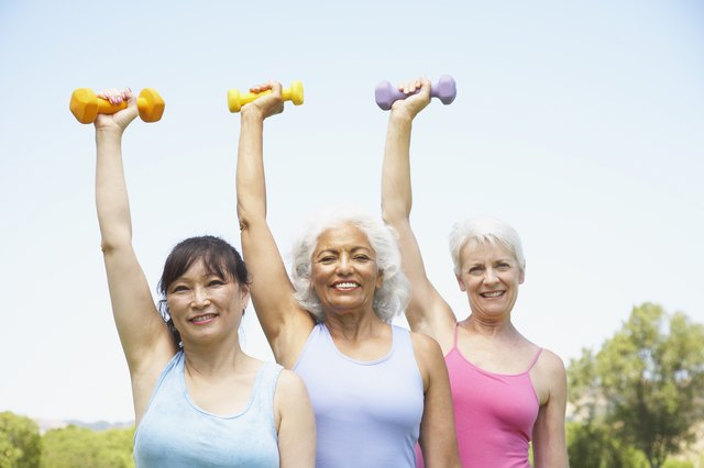Multi-ethnic senior women lifting weights