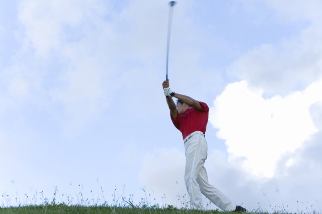 Man Swinging Golf Club