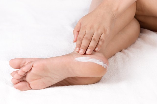 Applying cream to feet