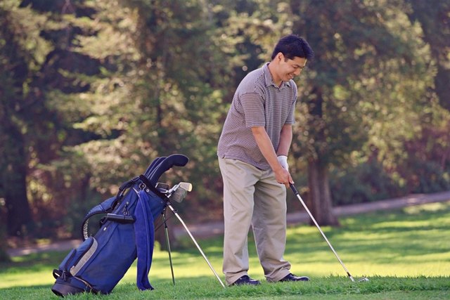 Asian man playing golf