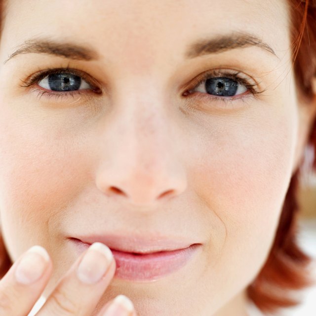 woman applying lip balm