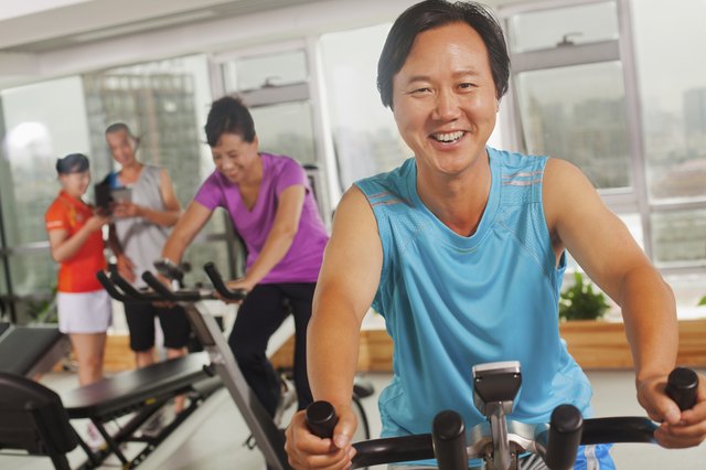 Man smiling and exercising on the exercise bike
