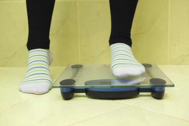 woman wants to weigh and stands on the scales