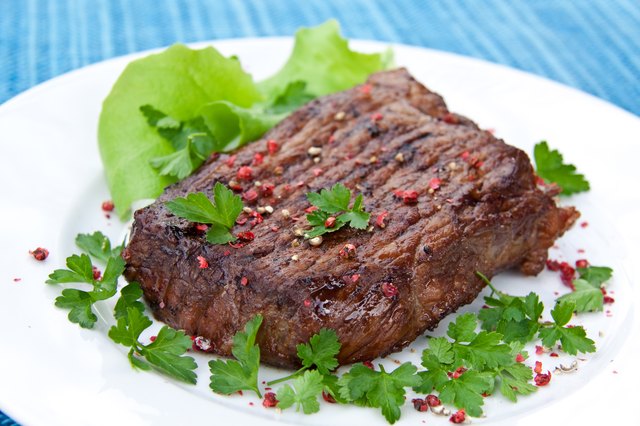 roast big steak on green dish close up