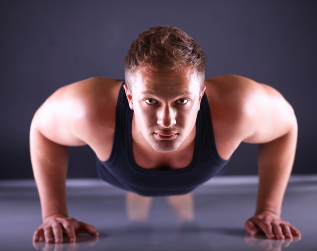 Fitness man doing push ups on floor