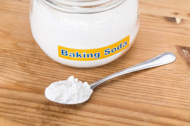 Jar and spoonful of baking soda for multiple holistic usages