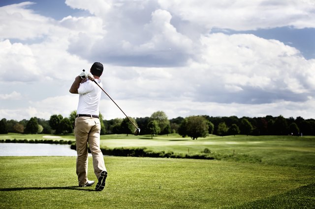 Golf player teeing off