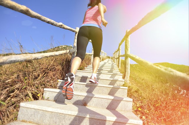 woman running up on mountain stairs