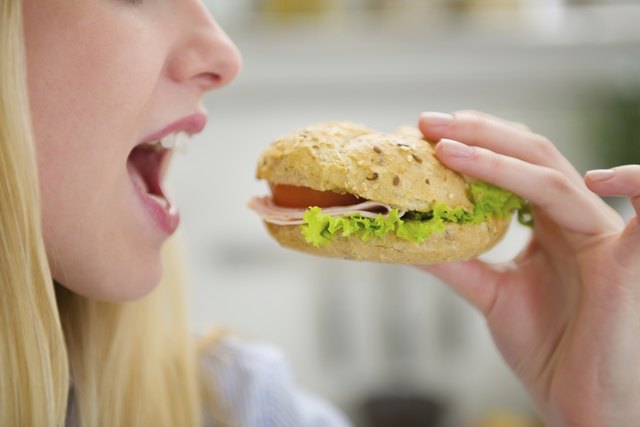 Closeup on teenager girl eating burger