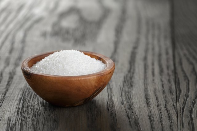 White sugar in olive wood bowl