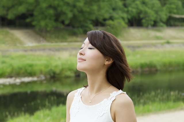 Asian girl beside river. breath and relax