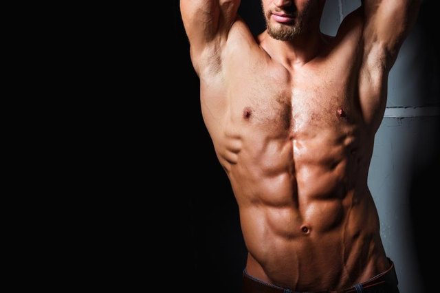 Muscular and sexy torso of young man with perfect abs. Athletic body of young hunk. Fitness concept.
