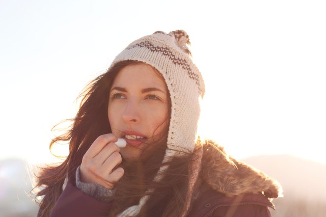 Women outdoor taking care of lips