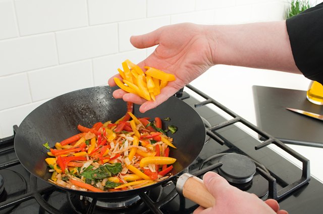 Man stir frying vegetables