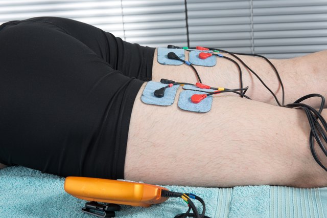 Man with electrostimulator electrodes on his body