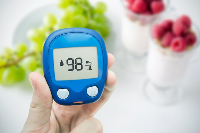 Diabetes doing glucose level test. Fruits in background
