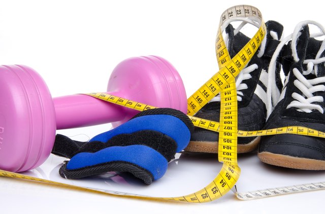 Pink dumbell, ankle weights and fitness shoes
