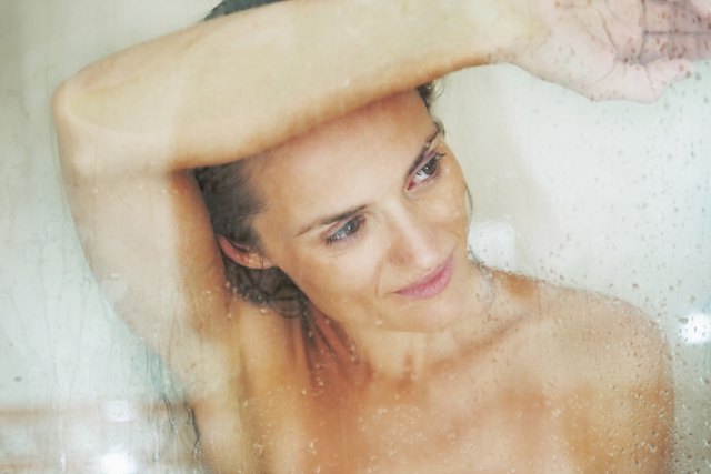 portrait of young woman behind shower door
