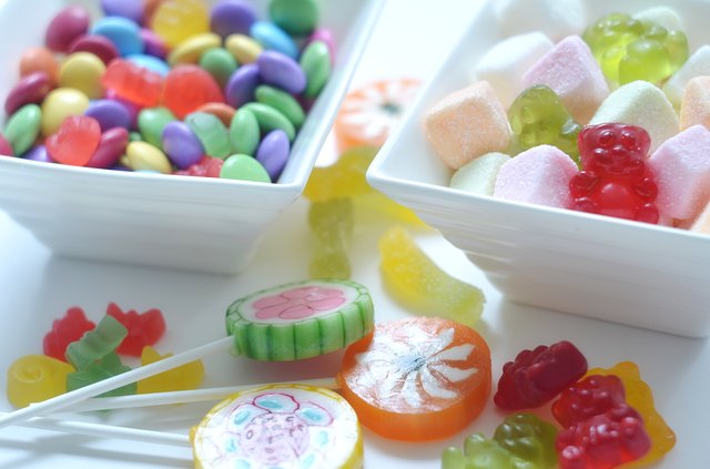 Two bowls of colored smarties and sour candies