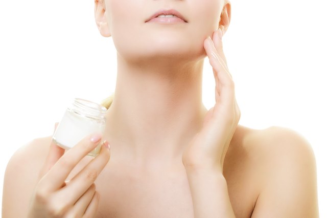 Skin care. Girl applying moisturizing cream