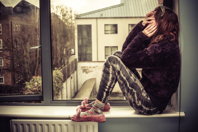 Sad woman by the window