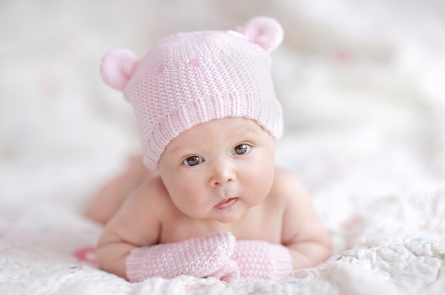 newborn baby girl in pink knitted bear hat