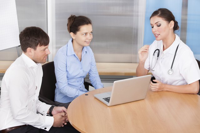 Female Doctor Explaining To Woman