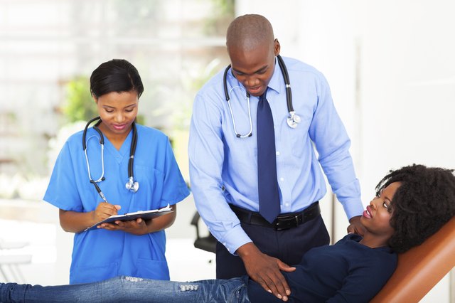 african doctor examining female patient