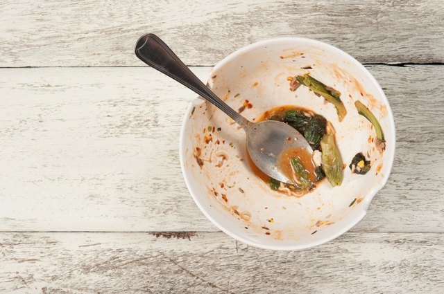 Empty dish after food on white wood