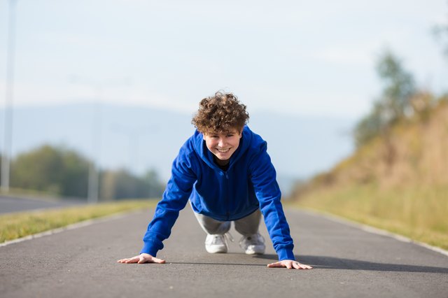Teenage boy exercising in park