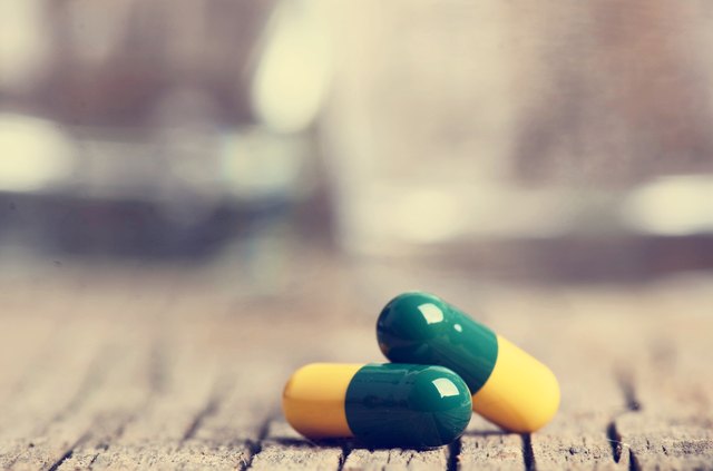 Pharmacy background. Pills on a wooden table. Medicine. Natural background