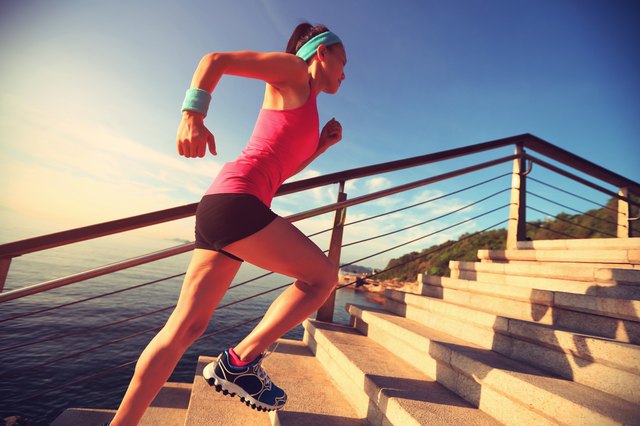 healthy lifestyle sports woman running up on stone stairs seaside