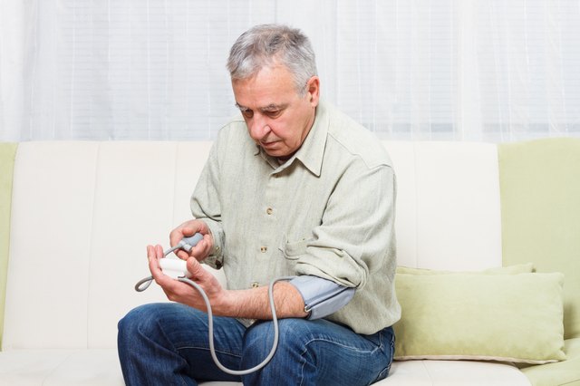Senior man measuring blood pressure