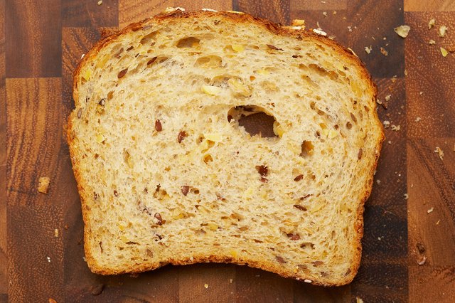 Slice of whole grain bread on cutting board