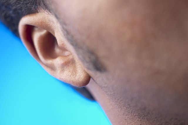 Close-up of man's sideburns and ear