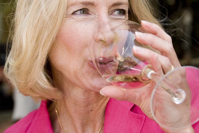 Close-up of mature woman drinking wine