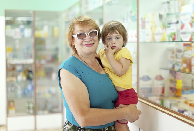 woman with child chooses drugs at pharmacy