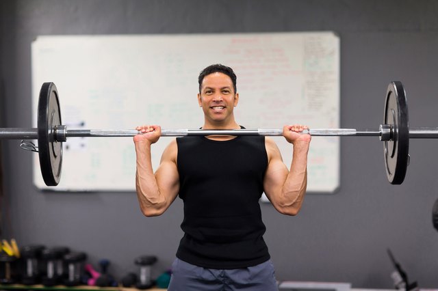 muscular man lifting weights