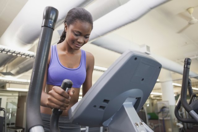 Fit woman working out on the cross trainer